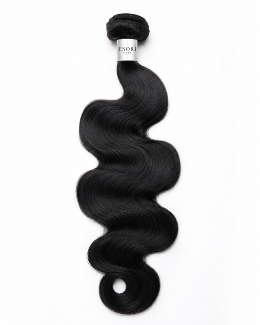 A single bundle of black body wave hair extensions with a silver band.